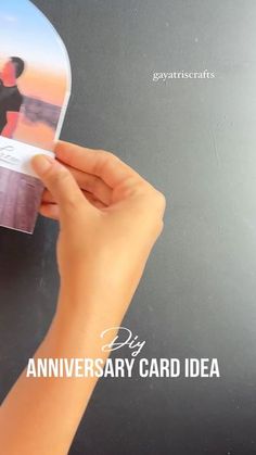 a person holding up a card with an image on it