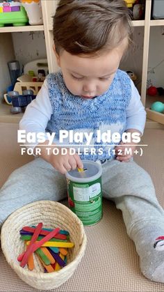 a little boy sitting on the floor playing with some sort of plastic letters and building blocks