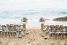 chairs set up on the beach for an outdoor ceremony