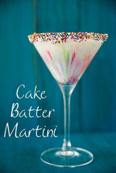 a martini glass filled with sprinkles on top of a table