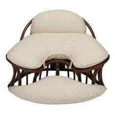 a wooden chair with two pillows on it's back and one cushion in the middle