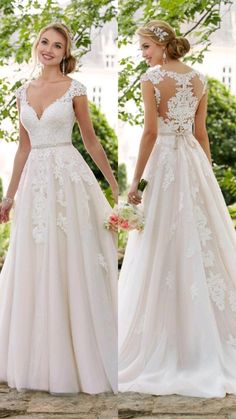 two women in wedding gowns standing next to each other