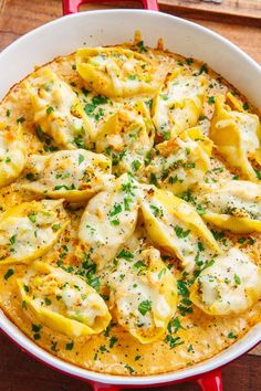 a casserole dish filled with ravioli and cheese