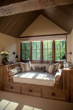 a large window seat with pillows on it