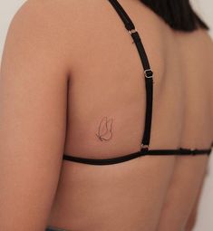 a woman with a small tattoo on her back