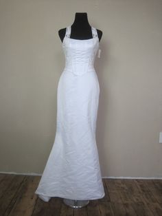 a white wedding dress on a mannequin