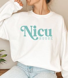 "Calling all NICU healthcare providers and nurses This sweatshirt is for you or someone you know in the Neonatal ICU! This unisex heavy blend crewneck is made of polyester and cotton to provide a comfortable and cozy feel. The collar is ribbed knit and retains its shape after every wash. A perfect Christmas, or Graduation gift.  WHAT IT SAYS:  NICU Nurse ITEM DETAILS:  -50% cotton, 50% polyester -Medium-heavy fabric  -Loose fit -Sewn-in label -Runs true to size, BUT if you're looking for a more \"baggy\" fit we suggest sizing up! **PLEASE NOTE! The print size/proportion may be slightly off on mock-up images *PLEASE NOTE the colors may appear slightly different or faded based on what color sweatshirt you purchase LOOKING FOR  THIS SWEATSHIRT IN ANOTHER DESIGN OR STYLE? CLICK ON OUR STOREFRO Sicu Nurse, Color Sweatshirt, Nurse Sweatshirt, Nicu Nurse, Nurse Practitioner, Baggy Fits, Nurse Gifts, Perfect Christmas, Heavy Fabric