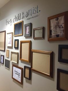 there are many framed pictures on the wall and one is saying every child is an artist