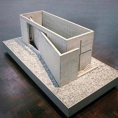 a model of a building on display on a wooden floor