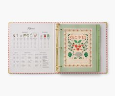 the recipe book is open to show it's cover and contents, including apples