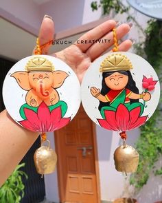 two round earrings with cartoon characters hanging from it's ear ends, in front of a house