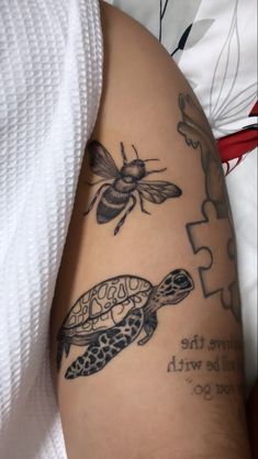 a woman with a tattoo on her arm has a puzzle piece and a bee next to it