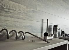 there are many different items on the counter top in this room, including pipes and fittings