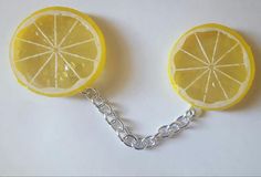 two slices of lemon are attached to a chain