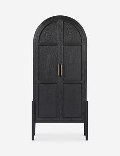 an arched wooden cabinet with two doors on the front and one door in the back