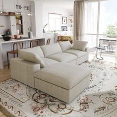 a living room filled with furniture and a large rug