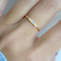 Sweet, simple, and dainty ring. Perfect for a minimalist look, or for stacking. - - - D E T A I L S - - - * Made of 925 Sterling Silver * Available in 14k Gold, Rhodium, or Rose Gold plated * We use a THICK plating - for a piece that will last you years to come! * VERY HIGH QUALITY * Made of the highest grade of cubic zirconia stones for an authentic look * Available in sizes 4, 5, 6, 7, 8, 9, or 10 Also available the following Stone Colors: ● SAPPHIRE https://www.etsy.com/listing/1103205007/sap Layering Diamond Necklaces, Simple Diamond Ring, Opal Stacking Ring, Sterling Silver Opal Ring, Silver Opal Ring, White Opal Ring, Baguette Ring, Zierlicher Ring, Opal Ring Gold