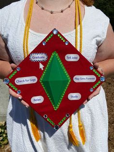 a woman holding a red and green object with words on it