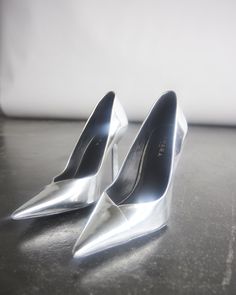 Divine minimalism is revealed by Sloane Sq elegant stiletto pump. Our beautiful sole is underset by our feature heel with a metal top piece, signature of the brand, in metallic silver. Refined elegance at its best. Handmade in Brazil. You can request a refund within 14 days. Follow our return instructions here. Silver Stiletto Heels, Silver Heels Aesthetic, Heels Aesthetic, A Level Textiles, Silver High Heels, Silver Pumps, Metallic Heels, Silver Heels, Silver Shoes