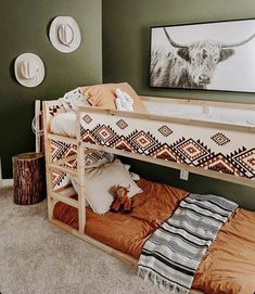 a bunk bed with an animal painting on the wall