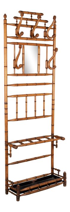 an antique bamboo bed frame with mirror on the top and shelf below it, isolated against a white background