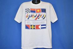 Chest 24 in.Length 26 in. Tag Says: Fruit of the Loom, Extra Large, 100% cotton, Made in USAThis shirt is for St. Thomas in the Virgin Islands and features a graphic of sailboats and maritime signal flags. St. Thomas is the gateway Isle of the US Virgin Islands and it is known for its beaches and snorkeling spots.Comments: Fits like a modern unisex adult extra large. Oversized, baggy fit.   21-02-108606 Nautical Cotton T-shirt With Graphic Print, Nautical Style Cotton T-shirt With Short Sleeves, Nautical Cotton T-shirt With Short Sleeves, Nautical Cotton T-shirt For Summer, Nautical White T-shirt With Graphic Print, Nautical Cotton Tops With Graphic Print, Nautical Style Cotton T-shirt With Graphic Print, Sailing Flags, Maritime Signal Flags