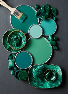 green and gold plates with paint brushes on them