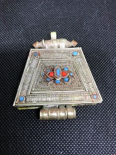 "Beautiful antique Tibetan gau box pendant with Turquoise and Coral. Gau box necklaces are worn by women in the Himalayas. Gau is a protective amulet box and is worn hanging from the neck. A chain can be threaded through the top of the box. The front has beatiful silver filigree work and other applique wire work. It is made from a silver alloy and the back sheet is copper with a lotus flower stamp. The box can open and close nicely to put prayers or herbs inside. It measures about 2.5\" long by Traditional Rectangular Necklace For Festivals, Antique Jewelry With Intricate Design For Puja, Traditional Locket Jewelry For Rituals, Traditional Jewelry With Large Square Pendant, Traditional Medallion Jewelry For Puja, Traditional Collectible Necklace For Festivals, Traditional Bronze Locket Jewelry, Traditional Blue Patina Necklace, Collectible Spiritual Rectangular Jewelry