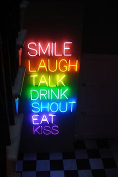 a neon sign that says smile laugh talk drink shut eat kiss