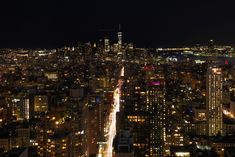 an aerial view of the city at night from top of a skyscraper in new york