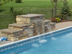 a swimming pool with waterfall and fire hydrant