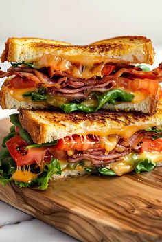 two sandwiches stacked on top of each other with meat and vegetables in between the sandwich halves