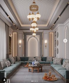 a large living room with couches, tables and chandeliers on the ceiling