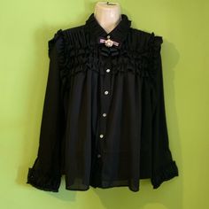 Black Long Sleeve Blouse Ruffle Details In Neck, Chest And Wrist, Pearl Buttons On Sleeves ( Wrist Button Only For Ornament Unless The Buttonhole Is Opened A Little More So That The Button Can Pass Through) Removable Bow Neck( Pin Brooch) Bought It In A Boutique. Never Worn, Victorian Style Button Up Blouse Black Ruffled Button-up Blouse, Black Button-up Top With Ruffles, Mustard Cardigan, Floral Halter Top, Black Long Sleeve Blouse, Linen Top Women, Lace Blouse Long Sleeve, Eyelet Blouse, Floral Embroidered Top