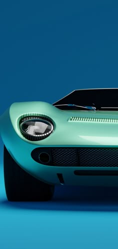 the front end of a green sports car on a blue background with no people around it