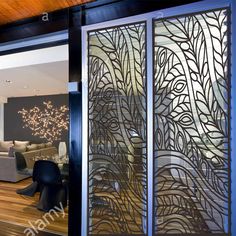 an open living room door with decorative glass panels on the outside and wood flooring