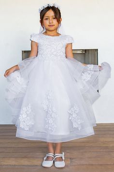 Your sweet girl will look timeless in this embellished white short sleeve dress with A-line layered tea length skirt by Cinderella Couture 2017. This elegant satin short sleeve tea length communion dress features a zipper back satin sash and is adorned with beaded 3D floral appliques. There's a hard net inside the skirt for puffiness. Girls Layered Short Sleeve Gown by Cinderella Couture 2017 Designer: Cinderella Couture Fabric: Satin, Glitter Tulle, Embroidery, 3D Floral Appliques, Beading, 100 White Short Sleeve Confirmation Dress, White Short Sleeve Dress For Confirmation, Short Sleeve Dress With Fitted Bodice For Confirmation, White Short Sleeve First Communion Dress For Pageant, Fitted First Communion Dress With Short Sleeves, Elegant First Communion Dress With Short Sleeves For Pageants, Short Sleeve Ruffled Dress For Confirmation, Spring First Communion Dress With Short Sleeves, Spring First Communion Dress With Fitted Bodice