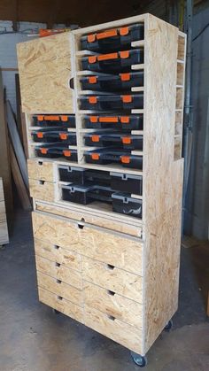 a large wooden cabinet filled with lots of black bottles and orange tags on it's doors