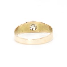 a yellow gold ring with a single diamond