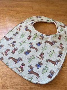 The Doxie Cowboy baby bib comes in two sizes, infant and toddler. A green background filled with topographical maps and 4x4's.  Features a 100% cotton Terry-cloth backing fabric, for extra absorbency. Color will be white or nuetral, depending on color in the primary fabric choice. Bibs snap together with KamSnaps quality snaps. Adjustable for two neck sizes.  Fabrics are pre-washed with free and clear laundry soap in warm water: no shrinking on our watch!  Need more info? Send us a message. Infant Cowboy Outfit, Cowboy Baby Blanket, Western Cowboy Baby Blanket, Western Baby Boy Blanket, Toddler Bib, Cow Nursery Bandanas & Bibs, Dream Kids, Baby Gadgets, Toddler Bibs