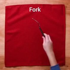 a pair of scissors is being used to cut fabric with the word fork on it