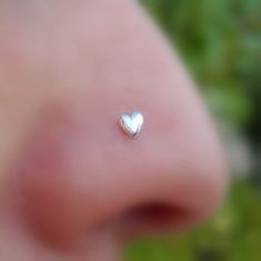 a close up view of a nose with a tiny heart on it