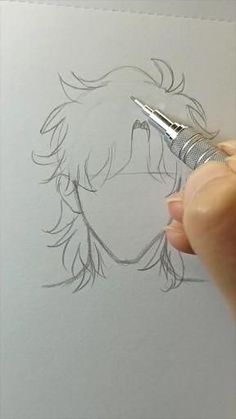 a person is drawing on paper with a pen