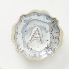 a silver plate with the letter a on it