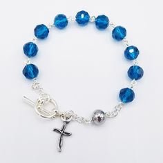 "This handmade rosary bracelet is made with 8mm royal blue Chinese crystal beads and an 8mm stainless steel Our Father bead featuring a 0.5\" cross charm. All findings are silver plated. All rosary parts are made in Italy. This bracelet is 7.5 inches long. Please choose a Patron Saint Medal to add to your bracelet! (included Each bracelet in my shop is handmade by yours truly. And I back all of my work with a 100% satisfaction guarantee. If you are not completely satisfied, please contact me dir Handmade Rosary, Rosary Bracelet, Our Father, Saints Medals, Patron Saints, Have A Blessed Day, Drawstring Pouch, Cross Charms, Prayer Beads