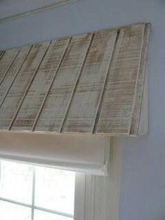 a window sill with a wooden blind over it