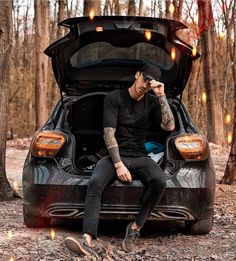 a man sitting in the trunk of a car