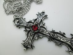 This Gothic cross necklace is an handmade pewter sculpture orned with an Austrian Swarovski or a real gem (My fav is the Black star Diopside, seriously) This gothic necklace is sold with a stainless steel chain of 18'' or 24'', if you would like to have a different length for the chain, you can write the desired length in the private note section when ordering :) This is a Gothic cross of 7cm This gothic cross necklace is a pewter sculpture of my own creation, i create and work the metal by myse Gothic Crucifix Cross Necklace As Gift, Gothic Crucifix Cross Necklace For Gift, Silver Cross Jewelry For Halloween, Gothic Cross Pendant Jewelry For Halloween, Gothic Cross Jewelry As Gift, Gothic Cross Jewelry Gift, Gothic Cross Jewelry For Gifts, Gothic Cross Necklace Gift, Halloween Silver Jewelry With Cross Pendant