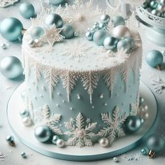 a frosted cake decorated with snowflakes and ornaments