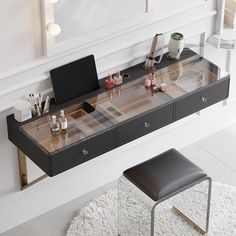 a desk with makeup and other items on it in a white room next to a chair